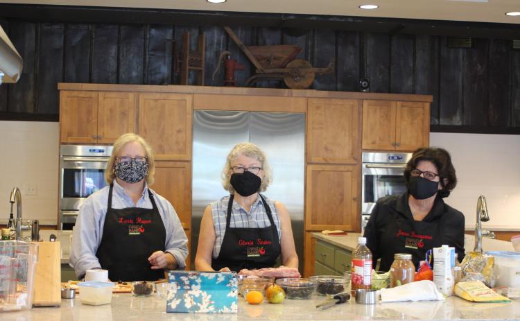 Megan Broome/The Clayton Tribune. Laura Hunter, left, Gloria Stokes and Joanne Baumgartmner are volunteers in the Food Bank of Northeast Georgia Teaching Kitchen and have stayed as they'e seen three teaching kitchen managers come and go. They say their passion for food, camaraderie and the community are what inspire them to volunteer.