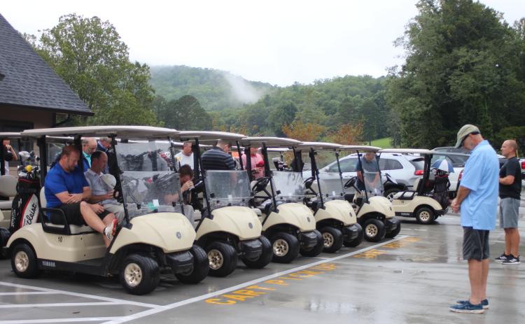 Megan Broome/The Clayton Tribune. Dr. Guy Gober and golf tournament contestants pray before the start of the 16th annual prostate cancer awareness tournament held at the Rabun County Golf Course last Saturday