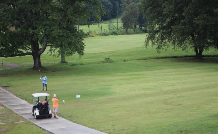 Megan Broome/The Clayton Tribune. Dr. Guy Gober, who organized the 16th annual prostate cancer awareness golf tournament, and partner Perry Thompson join as a team and play a round of golf to participate.