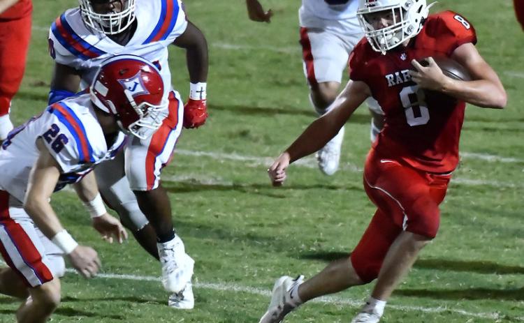 Photo courtesy of Scott Poss. The Wildcats’ Cory Keller swerves to avoid a Jefferson tackler.