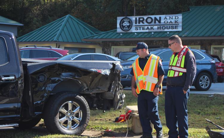 Megan Broome/The Clayton Tribune.Firefighter Hunter Hargrave, left,  and Assistant Fire Chief Justin Upchurch respond to the scene of a five-vehicle accident on Highway 441 at Bo James St. in Clayton on Monday.