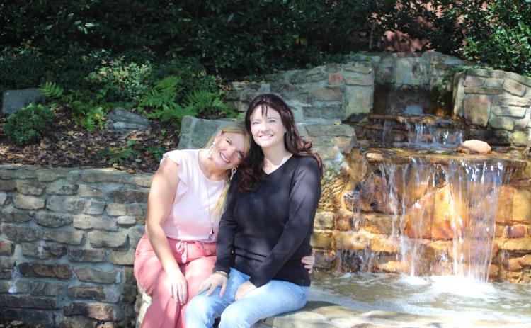 Megan Broome/The Clayton Tribune. Sisters Holly Cabe and Robin Billingsley are both breast cancer survivors and were both diagnosed at age 40. They advocate it's important to get yearly mammograms because they are the key for early detection.
