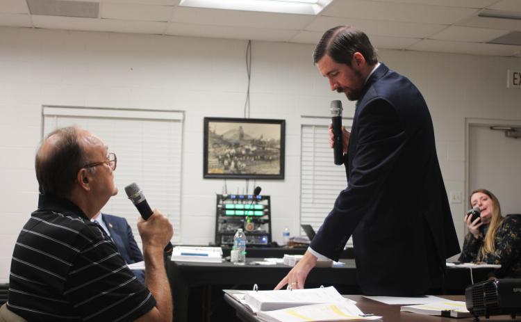 Megan Broome/The Clayton Tribune. David Irvin, left, is questioned by Tallulah Falls Town Attorney Warren Tillery at a hearing earlier this month to determine if J&D Irvin Holdings has a vested right to operate their short-term vacation rental business after a zoning map change.