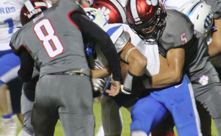 Andy Diffenderfer/The Clayton Tribune A Banks ballcarrier has nowhere to go as Hogan Woodard and Cory Keller combine on the tackle.