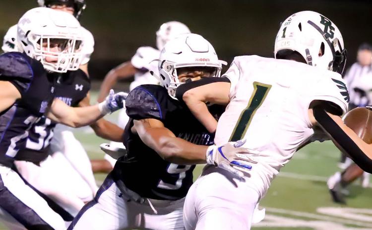 Photos courtesy of Rabun Gap-Nacoochee The Eagles’ Tucker Holloway tries to break free from Charlotte Christian tacklers.