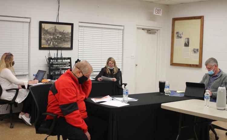 Megan Broome/The Clayton Tribune. Tallulah Falls City Clerk Linda Lapeyrouse, left, and Council Members Joey Fountain and Craig Weatherly receive the city’s fiscal year 2020 audit in a presentation from Joely Mixon of Mixon, Mixon, Brown and Tench CPAs at the Tallulah Falls town council meeting last Thursday.