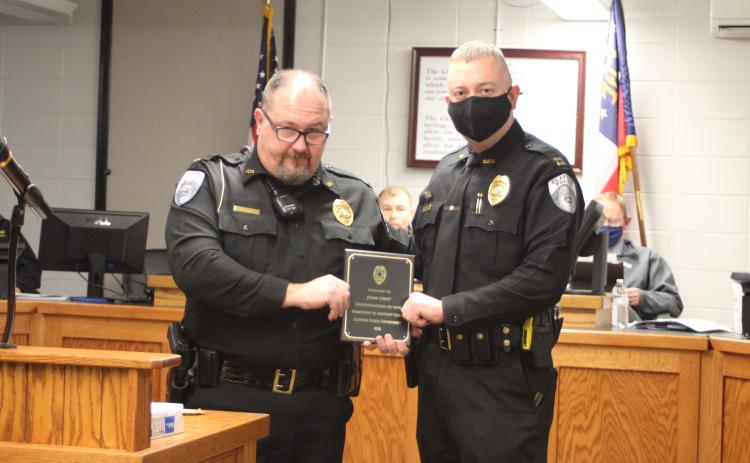 Megan Broome/The Clayton Tribune. Clayton Police Chief Andy Strait congratulates new Assistant Police Chief John Grist.