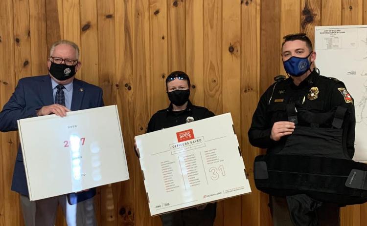 Submitted photo. Michael Palmer, president of North Georgia Mountains Lodge #112 of the Georgia State Fraternal Order of Police (FOP), left, presents Dillard Police Officer Victoria Hopper and Dillard Police Chief Jeremy Parker with ballistic vests from the FOPs “Protect the Protectors” program at last month’s Dillard City Council meeting.