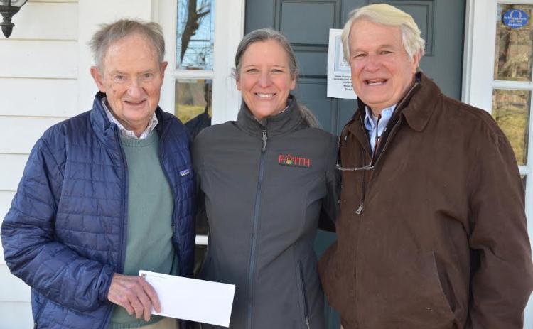 Wayne Knuckles/The Clayton Tribune. Lake Rabun Foundation Executive Director Steve Raeber, left, and Director Emertius Buz Stone, right, present a check for $10,000 to Fight Abuse in the Home (FAITH) Executive Director Caroline Wallis Monday. The contribution put the LRF's total giving to Rabun County at over $2 million.