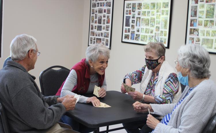 Megan Broome/The Clayton Tribune. Ronnie Balkcom, left, Nancy Phillips, Georgiann Wilson, and Peggy Thrasher play cards at the Rabun County Senior Center. The facility will open on Monday after being closed over a year due to the coronavirus pandemic.