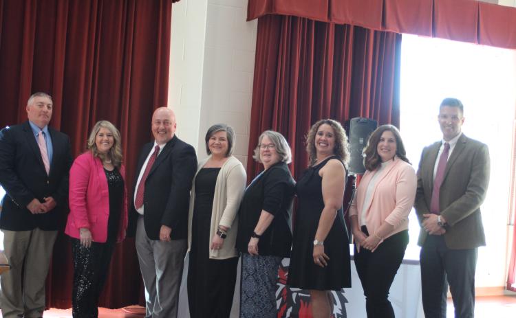 Megan Broome/The Clayton Tribune. Jonathan Welch, RCES Principal, left, Jaimie Crane, RCES and System Teacher of the Year, Jay Fowler, RCPS principal, Lynn Talley, RCPS Teacher of the Year, Kaye Collins, RCMS Teacher of the Year, Kechara Partin, RCMS principal, Alicia McCracken, RCHS Teacher of the Year, and Justin Spillers, RCHS principal, attend a banquet honoring the teachers of the year on April 15.