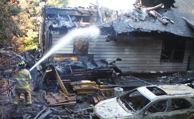 Megan Broome/The Clayton Tribune. Firefighters battle a blaze in the Vista Ridge Apartment Complex on Sunday.