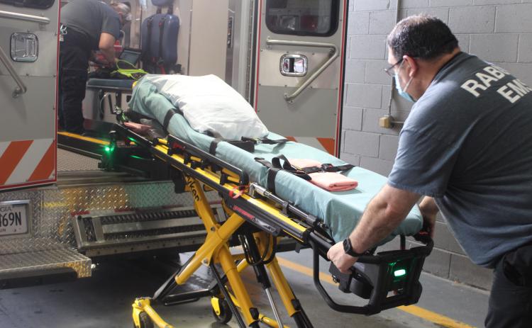 Megan Broome/The Clayton Tribune. Rabun County EMS paramedic Don White demonstrates how to use the new Stryker Power Load lift system on an ambulance. It’s an automated hydraulic lifting system that lifts patients who are on stretchers into and out of ambulances.