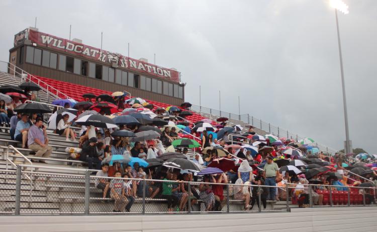 Megan Broome/The Clayton Tribune. Friends and family members of graduates brave the wind and rain to watch the Class of 2021 graduate. The ceremony had to be moved inside shortly after due to rain and threats of lightning strikes in the area.