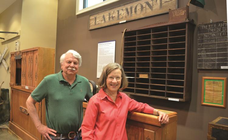 Wayne Knuckles/The Clayton Tribune. Volunteers Dick Cinquina, left, and Linda Bardin show some of the exhibits to be featured when the Rabun County Historical Society reopens Friday, June 11.