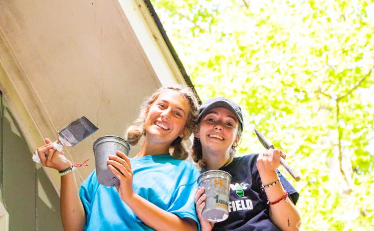 Submitted photo. Youth members of St. Ann’s Parish in Marietta, Ga. paint a home as a project for the Restore Mission Week with the Life Teen movement at Camp Covecrest recently..