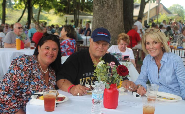 Megan Broome/The Clayton Tribune. Tena Johnson, left, Ron Johnson and Louise Dillard enjoy live entertainment from Chris Blue at The Dillard House on Sunday.