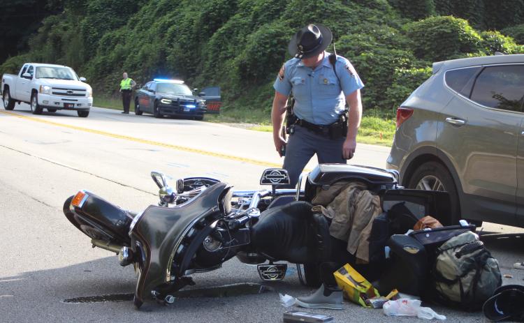 Megan Broome/The Clayton Tribune. A Florida couple was injured following a motorcycle accident at Highway 441 and Cross St. in Mountain City Sept. 2. Georgia State Trooper Brady Galloway works the accident scene.