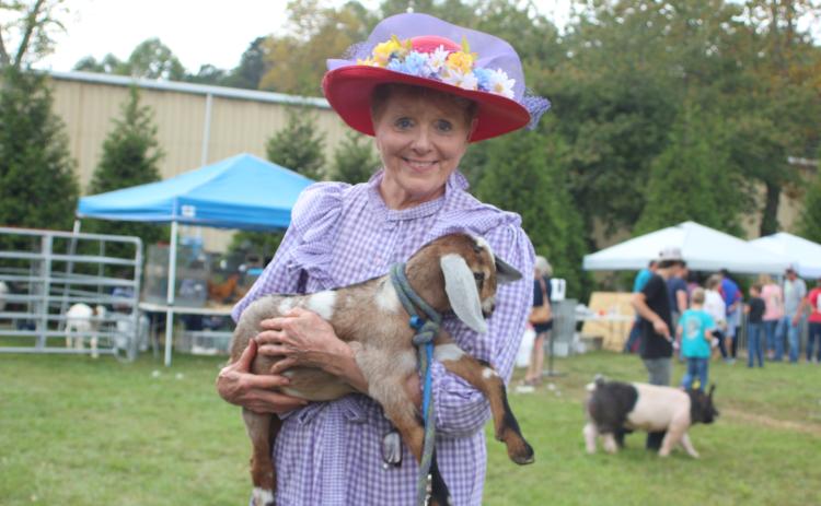 Megan Broome/The Clayton Tribune. Marywinn Lent is with a 5-week-old goat named spot at the Foxfire Mountaineer Festival last Saturday.
