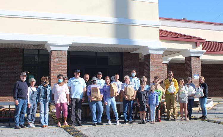 Megan Broome/The Clayton Tribune. Law enforcement officers, volunteers from Fight Abuse in the Home (FAITH) and local churches participated in the Faith and Blue event last Saturday at the Food Bank of Northeast Georgia.