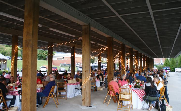 Photo courtesy of Elizabeth Adams. Guests enjoy a picnic style meal while listening to the Foxfire Boys at the Picnic for a Purpose.