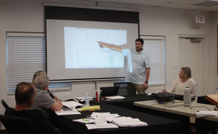 Megan Broome/The Clayton Tribune. Brian Irvin, left, presents renderings of what a short-term rental development planned for Tallulah Falls is expected to look like to zoning board members last Thursday.