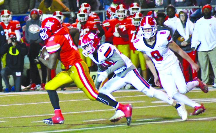 Enoch Autry/The Clayton Tribune. Rabun County defenders Will Turpin and Cory Keller try to track down Thomasville running back Malik Harper. The Bulldogs advanced to the Class AA semifinals against Callaway.
