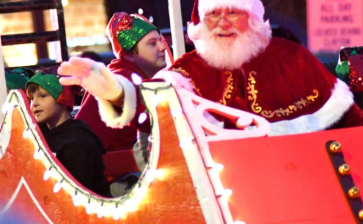 Enoch Autry. Santa waves to all the nice Rabun County children as his lit sleigh rolls down Main Street.