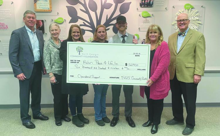 Photo submitted courtesy Margaux Dolenc. North Georgia Community Foundation board member Rob Fowler (from left); Debbie Dalhouse, Paws 4 Life volunteer; Jennifer Marcellino, Paws 4 Life CEO; Becca McClain, shelter director; Everett Lampros, shelter public relations manager; and Robert Shippey and Linda Foster, North Georgia Community Foundation board members, pose with a $6,619 North Georgia Community Foundation Grant check awarded to Paws 4 Life.