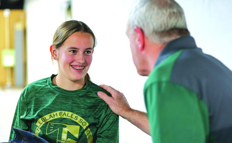 Photo courtesy Austin Poffenberger. Tallulah Falls freshman Kylee Loudermilk talks with Rifle Program Head Coach Tim Stamey during the Indians’ win against Dawson County.