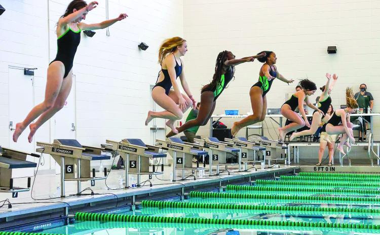 Photo courtesy of Austin Poffenberger. Emily Wolfe (from left), Karis Tatum, Daya Ssemakula, Tamia Moss, Hannah Hickox, Tillie Crumley and Montgomery Dampier jump into the pool after winning the girls’ 1A swimming championship.