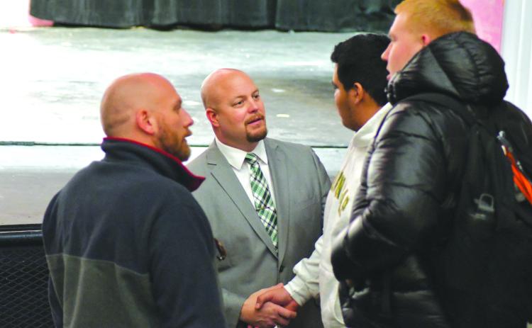 Enoch Autry/The Clayton Tribune. New Rabun Gap-Nacoochee head football coach Derek White (center) talks with his Eagle student-athletes Tuesday morning during an introduction ceremony at the school. White comes to RGNS after guiding five state-title winning football programs.