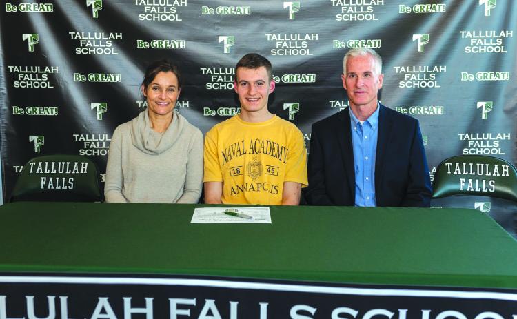 E.Lane Gresham/Tallulah Falls School. Tallulah Falls senior Evan Prince signed a national letter of intent with the U.S. Naval Academy Tuesday with his parents Debbie and George next to him.