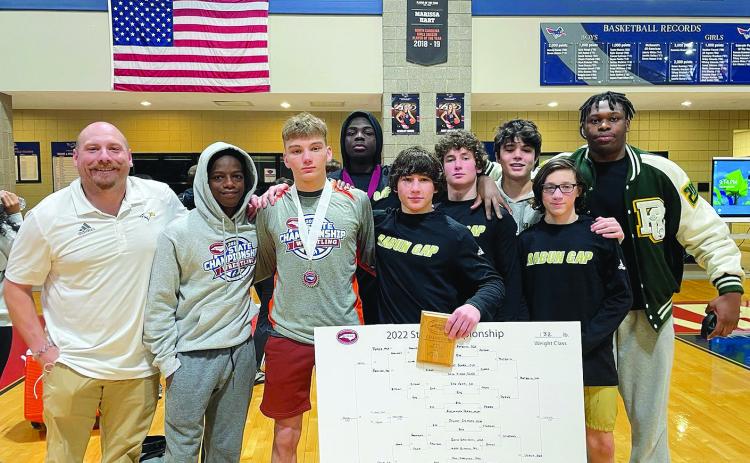 RGNS Atheltics. RGNS head wrestling coach Conor Bozzi (far left) stands with his team at state Benit Namahoro Jabo, Fisher Bejnerowicz, Mike Lengi, Clay Unruh, Cash Unruh, Rocco Toogood, Foster Duquette and Gideon Herbert.