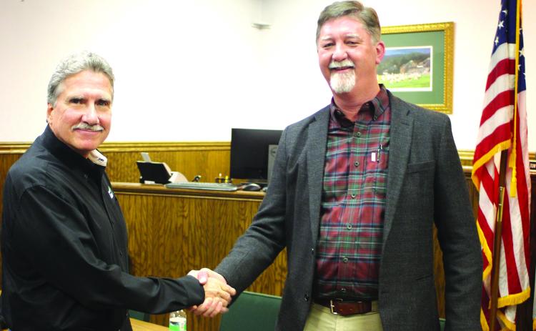 Megan Broome/The Clayton Tribune. After the Rabun County commission and Clayton city council unanimously vote Feb. 17 on a Service Delivery Strategy agreement, Commission Chair Greg James and Clayton Mayor Kurt Cannon shake on the decision.