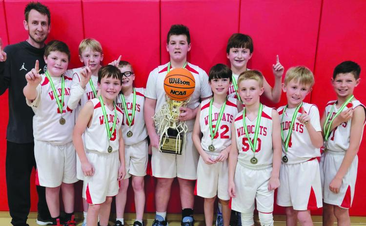 Submitted photo. The Rabun County 10-and-under boys recreation department basketball team won the county's first state Georgia Recreation and Park Association state championship on March 5. Pictured are the winning players and their trophy with Coach David Adcock. Not pictured is Coach Kristina Burrell.