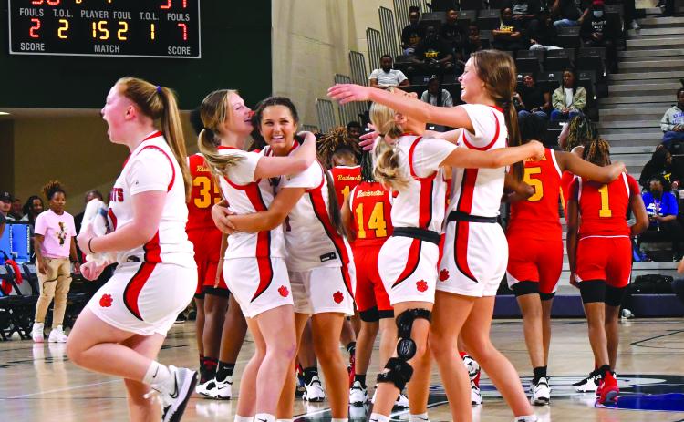 As the final seconds tick off the clock, the Rabun County fans and Ladycat bench come to their feet to celebrate the girls’ 50-39 Class AA Final Four victory as freshman Jacie McCall (14) even shows off her biceps. RCHS plays Elbert County March 10 for the state title.