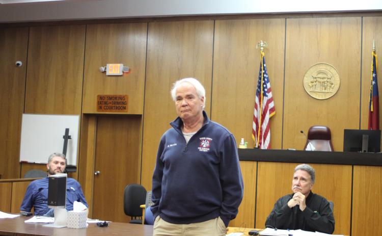 Megan Broome/The Clayton Tribune. Firefighter Gordon Van Mol addresses fellow first responders and attendees during a presentation at the Rabun County Board of Commissioners meeting Feb. 22 and thanks them for saving his life after he went into cardiac arrest while battling a brush fire Nov. 27. The first responders were presented with plaques for their heroic efforts. “These people are at their best when you are at your worst,” a tearful Van Mol said.