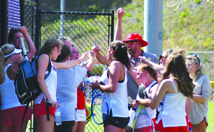 Enoch Autry/The Clayton Tribune. With RCHS head coach Bryan Getty, the Ladycat tennis team celebrates its 3-1 win over visiting Bacon County to advance to the Class AA Elite Eight. RCHS plays at fellow No. 1 seed Berrien Monday morning.