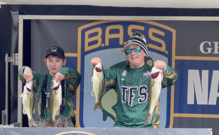TFS Athletics. Middle schoolers DJ Broome and Jack Thomson hold the bass that helped them finish in 16th place at the Lake Lanier tournament.