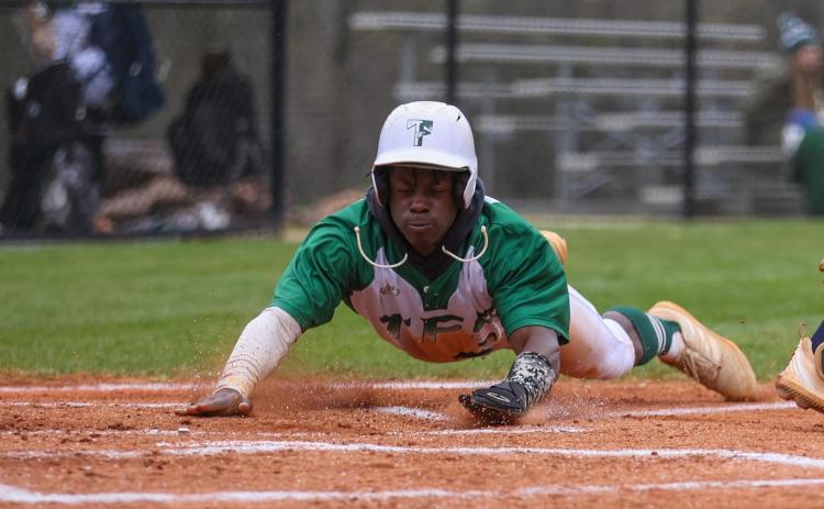 Photo by Austin Poffenberger. Joel Miller slides in safely at home for the Tallulah Falls Indians.