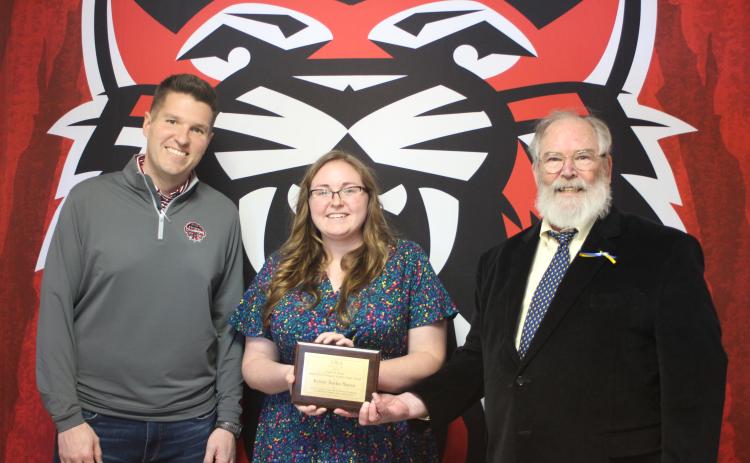 Megan Broome/The Clayton Tribune. RCHS teacher and UNG graduate student Kelsie Burks Mayes, center, is presented with the Appalachian Studies Association 2021 Carl A. Ross Appalachian Graduate Student Paper Award by Dr. Barry Whittemore, lecturer at UNG. RCHS Principal Justin Spillers stands to the left.