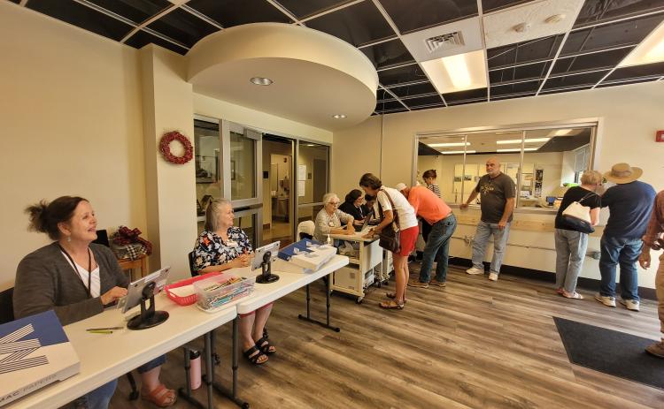 Megan Broome/The Clayton Tribune. A group of voters cast their ballots during advanced voting on Tuesday at the Rabun County Board of Elections Office on South Main Street in Clayton. Early voting continues to May 20 for the May 24 election.