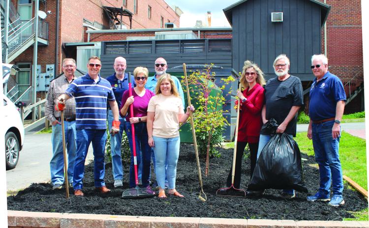 Megan Broome/The Clayton Tribune. Clayton Downtown Development Authority (DDA) members and Rotarians from the Rotary Club of Clayton plant flowers and a tree at the Charlie Mac Dickerson Memorial Park recently. Pictured are Keith Jackson; Tony Penrose; Matt Mitcham; Cassandra Clouser; DDA chair; Leif Ericson; Sonya Shook; Karen Bacon; Jim Antosiak; and Jef Fincher, Rotary Club of Clayton president.