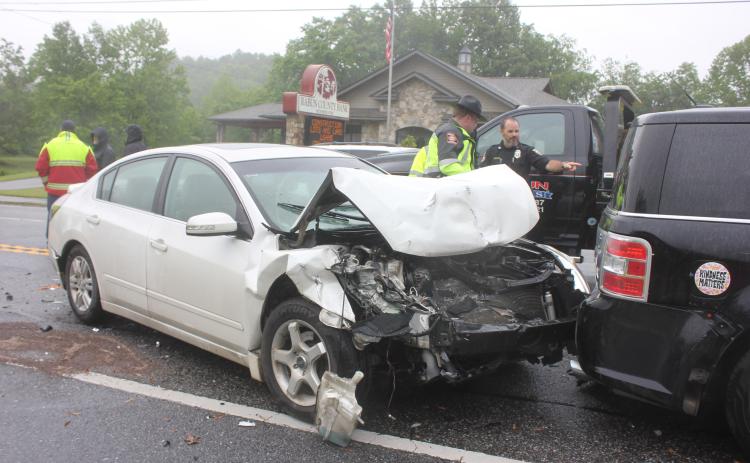 Megan Broome/The Clayton Tribune. Law enforcement officials inspect the damage from a three-vehicle crash that occurred in Dillard Monday.