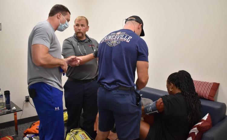 Submitted photo. Gainesville Fire Department Captain and Paramedic, and Clayton resident, Jordan Green, second from left, competes in the 2022 Georgia Police and Fire Games with fellow coworkers. The team took home second place in the Medic Challenge part of the games on June 23. Pictured are Eron Sunshine, program director for paramedic Studies at Lanier Technical College, Green, and Firefighter and Paramedic Josh Crawford, helping an actor during the Medic Challenge.