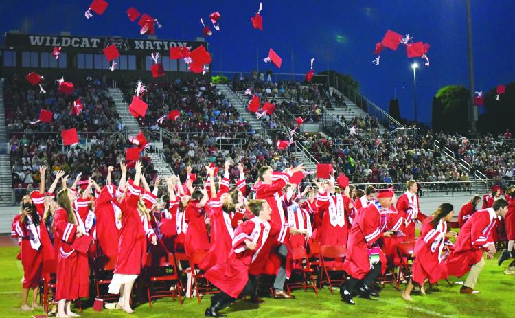 Enoch Autry/The Clayton Tribune. The Rabun County High School graduates of the Class of 2022 throw their caps into the air at the May 27 ceremony at Frank Snyder Memorial Stadium and race to the bell.