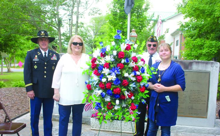 Megan Broome/The Clayton Tribune. Roger Glenn, United States Army Military Police Officer, Cindy O’Neil, Chris Dinofrio and Crystal Zajdowicz Cross place a wreath in honor of the men and women who fought and died for our country. Glenn was the speaker at the event.