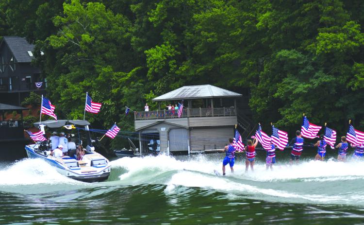 Enoch Autry/The Clayton Tribune. The skiers are pulled by the boat across the waters on Lake Burton.