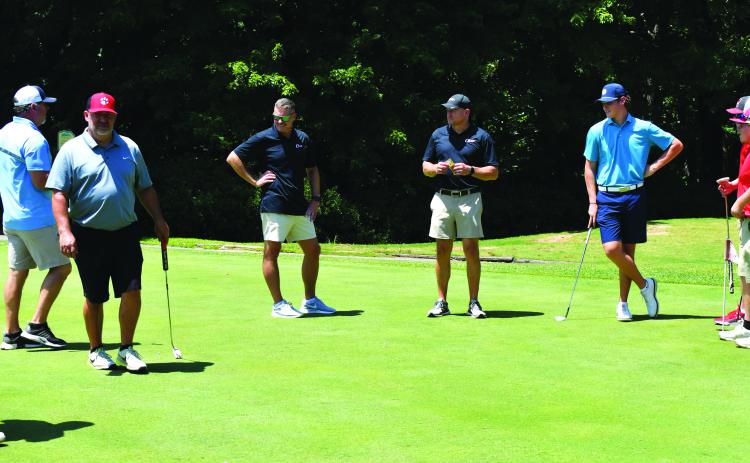 Enoch Autry/The Clayton Tribune. Players spend some time on the practice putting greens at Kingwood Resort Golf Course prior to the start of the inaugural Rabun County Booster Club Wildcat Open Golf Tournament on July 22. The event raised more than $9,000 to go toward the sports teams at the middle school and high school.